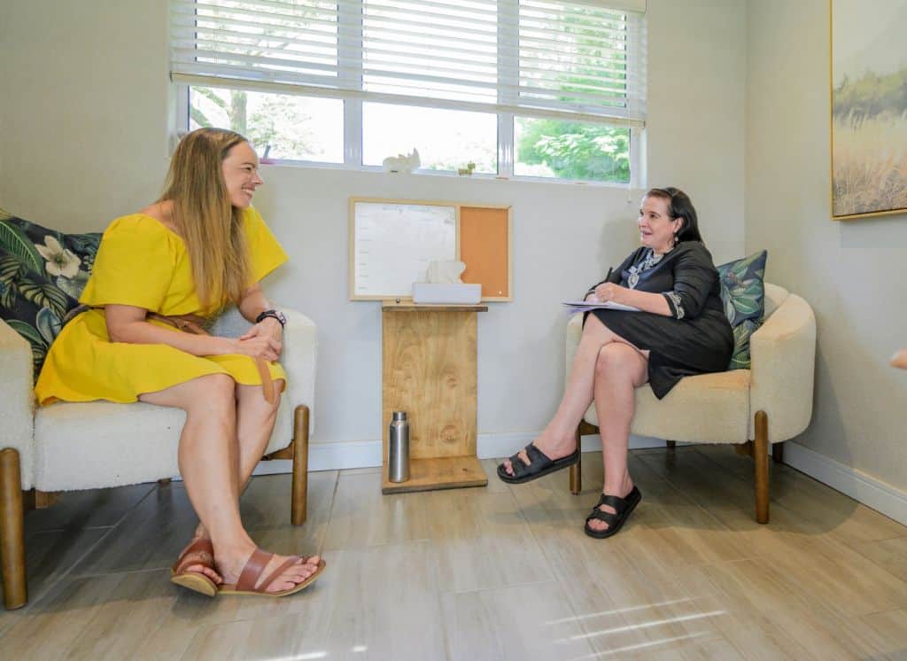 young woman talking to therapist while having a mental health counseling session