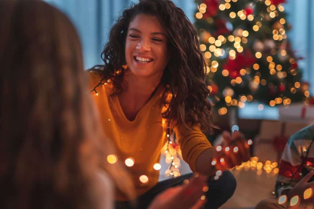 mother and daughter happily decorating for the holiday season