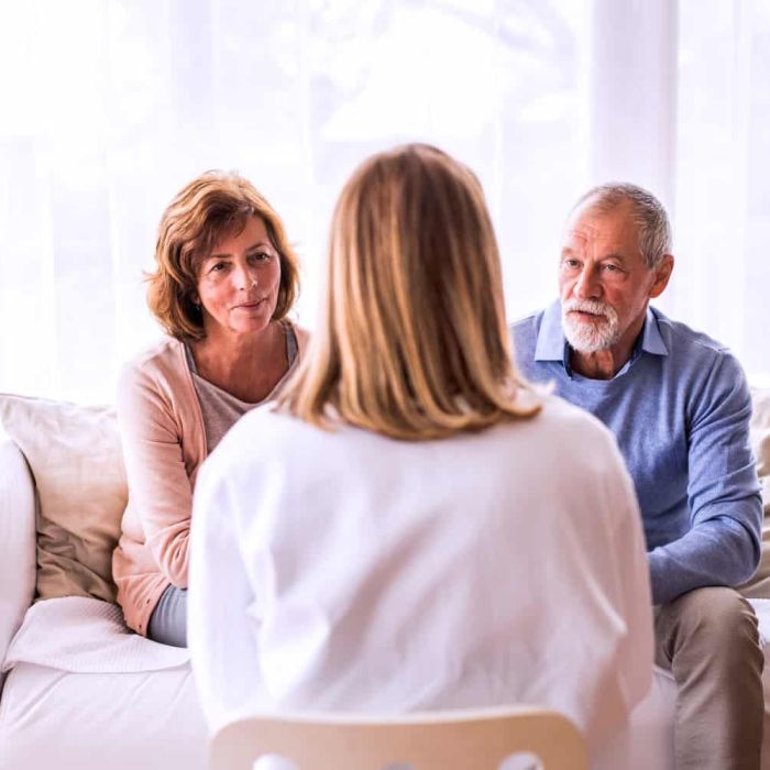 Female therapist talking to a senior couple