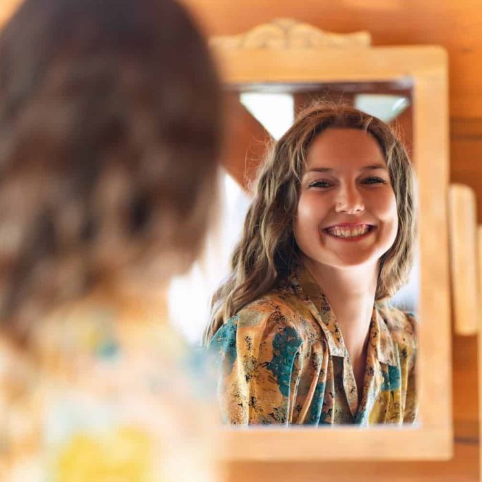 Woman looking herself in a mirror
