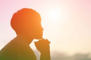 blurred, tinted image of woman looking, smiling at sunset, concept of self, thinking