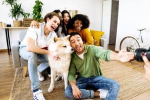 group of friends taking a happy photo with their dog, concept of strong support system