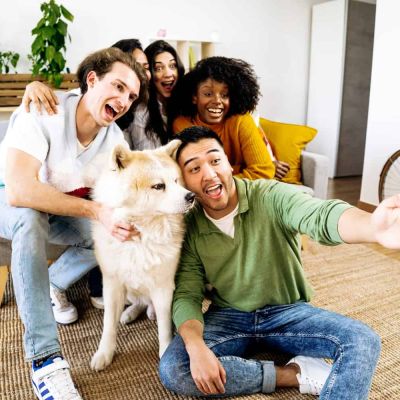 group of friends taking a happy photo with their dog, concept of strong support system